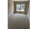 Cozy bedroom featuring neutral carpet and large window at 2221 Valley Edge Dr # 100, Raleigh, NC 27614
