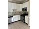 Updated kitchen with stainless steel appliances, white cabinets and tiled backsplash at 2221 Valley Edge Dr # 100, Raleigh, NC 27614