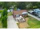Aerial view of a charming brick home with a front deck, an American flag, and mature trees at 306 Mitchell Ave, Franklinton, NC 27525