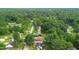 Aerial view of a residential area with tree-lined streets and well-maintained homes with manicured lawns at 306 Mitchell Ave, Franklinton, NC 27525
