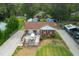 Aerial view of a brick home with a front deck, a well-manicured lawn, and a gravel driveway at 306 Mitchell Ave, Franklinton, NC 27525