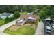 Aerial view of a well-maintained home with a deck, gravel driveway and fenced yard with mature landscaping at 306 Mitchell Ave, Franklinton, NC 27525
