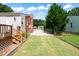 The backyard features a well-maintained lawn, with a mix of green grass and gravel areas, perfect for outdoor activities at 306 Mitchell Ave, Franklinton, NC 27525