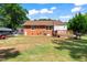 The backyard showcases a lush lawn, blending green grass with a gravel area for relaxed outdoor living at 306 Mitchell Ave, Franklinton, NC 27525