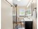 This bathroom has a glass shower, and standard toilet and sink with storage space at 306 Mitchell Ave, Franklinton, NC 27525