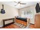 Cozy bedroom featuring hardwood floors, a ceiling fan, and a built-in storage bed at 306 Mitchell Ave, Franklinton, NC 27525