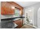 Functional kitchen offering dark countertops, wood cabinets, and stainless-steel appliances at 306 Mitchell Ave, Franklinton, NC 27525