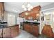 Functional kitchen with dark countertops, wood cabinets, and access to additional storage at 306 Mitchell Ave, Franklinton, NC 27525