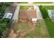 Aerial view of a home with a brick exterior, a wooden deck, a fenced yard, and mature landscaping at 306 Mitchell Ave, Franklinton, NC 27525