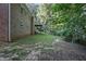 Side view of brick house with walkout wooden deck, and a lush backyard area at 3863 Avents Ferry Rd, Sanford, NC 27330