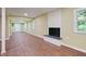 A long view of the finished basement with hardwood floors and a brick fireplace at 3863 Avents Ferry Rd, Sanford, NC 27330