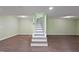 Stairs in a finished basement with hardwood floors and green walls at 3863 Avents Ferry Rd, Sanford, NC 27330