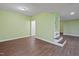 Large basement space with hardwood floors, green walls and stairs at 3863 Avents Ferry Rd, Sanford, NC 27330