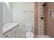 Bathroom featuring a vanity, toilet, and tiled shower with a rainfall showerhead at 3863 Avents Ferry Rd, Sanford, NC 27330