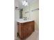 Close-up of bathroom vanity with white countertop, framed mirror and decorative carvings at 3863 Avents Ferry Rd, Sanford, NC 27330