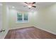 Bedroom with hardwood floors, a ceiling fan, and a large window at 3863 Avents Ferry Rd, Sanford, NC 27330