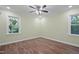 Bright bedroom with hardwood floors, ceiling fan and two windows with natural light at 3863 Avents Ferry Rd, Sanford, NC 27330
