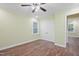 Bedroom featuring hardwood floors, a ceiling fan, and double door closet at 3863 Avents Ferry Rd, Sanford, NC 27330
