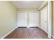 Spacious bedroom with two closets, wood flooring, and neutral walls at 3863 Avents Ferry Rd, Sanford, NC 27330