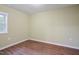 Empty bedroom with wood-look flooring, neutral paint, and a bright window at 3863 Avents Ferry Rd, Sanford, NC 27330