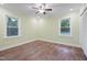 Bedroom featuring hardwood floors, a ceiling fan, and two large windows at 3863 Avents Ferry Rd, Sanford, NC 27330
