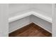 Interior view of a closet with white shelving and wood flooring at 3863 Avents Ferry Rd, Sanford, NC 27330