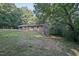 Brick home on a hill with well-maintained landscaping and mature trees at 3863 Avents Ferry Rd, Sanford, NC 27330