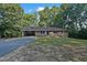 Beautiful brick home with a blue front door, covered carport, and well-maintained lawn at 3863 Avents Ferry Rd, Sanford, NC 27330