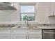 Modern kitchen with white cabinets, granite countertops, stainless steel appliances, and a window with a view at 3863 Avents Ferry Rd, Sanford, NC 27330
