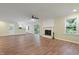 Bright living room with wood floors, fireplace and an adjacent updated kitchen at 3863 Avents Ferry Rd, Sanford, NC 27330