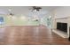 Open living space with updated kitchen area, ceiling fans, and wood-look flooring at 3863 Avents Ferry Rd, Sanford, NC 27330
