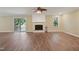 Living room featuring a fireplace, sliding glass doors and wood-look flooring at 3863 Avents Ferry Rd, Sanford, NC 27330