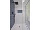 Contemporary shower with navy and white tiles, modern fixtures, and glass enclosure at 3863 Avents Ferry Rd, Sanford, NC 27330