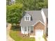 Charming two-story townhome with a brick and siding exterior, a well-manicured lawn, and an attached one-car garage at 428 Grand Pointe Dr, Garner, NC 27529