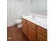 Standard bathroom featuring a toilet, shower with curtain and vanity with wood cabinets and a white countertop at 428 Grand Pointe Dr, Garner, NC 27529