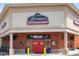 Exterior of Lorraine's Coffee House & Music with red doors, red brick and the sign in front at 428 Grand Pointe Dr, Garner, NC 27529