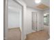 Hallway featuring carpet floors, white paint and two doors, one leading to a bedroom and one to a bathroom at 428 Grand Pointe Dr, Garner, NC 27529