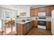 Bright kitchen with wood cabinets, stainless steel appliances, and a breakfast nook with natural light at 428 Grand Pointe Dr, Garner, NC 27529