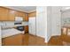 Spacious kitchen featuring wood cabinets, white appliances, and hardwood floors at 428 Grand Pointe Dr, Garner, NC 27529