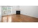 Bright and airy living room featuring hardwood floors, a fireplace, and sliding door access to a patio at 428 Grand Pointe Dr, Garner, NC 27529