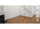 Open living room with hardwood floors, a staircase, a fireplace, and white paint at 428 Grand Pointe Dr, Garner, NC 27529