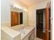 Bathroom with vanity and sink, large mirror with lights, and a doorway to the hall at 4324 Garland Dr, Raleigh, NC 27606