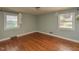 Bedroom showcasing hardwood floors and natural light from two windows at 4324 Garland Dr, Raleigh, NC 27606