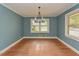 Dining room features hardwood floors, chandelier and a large window providing plenty of natural light at 4324 Garland Dr, Raleigh, NC 27606