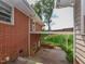 Brick house exterior featuring an open carport and a sloped yard at 4324 Garland Dr, Raleigh, NC 27606