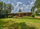 Charming brick home with a well-kept lawn and decorative metal garden beds at 4324 Garland Dr, Raleigh, NC 27606