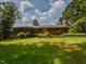 A charming single-story brick home with a well-manicured lawn and decorative planters at 4324 Garland Dr, Raleigh, NC 27606