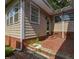 Rear exterior with brick patio steps and access to the house at 4324 Garland Dr, Raleigh, NC 27606