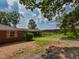Exterior view of a brick home featuring a large yard, a fence, and a carport at 4324 Garland Dr, Raleigh, NC 27606