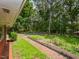 Brick pathway to the house with greenery and a lush treed yard at 4324 Garland Dr, Raleigh, NC 27606